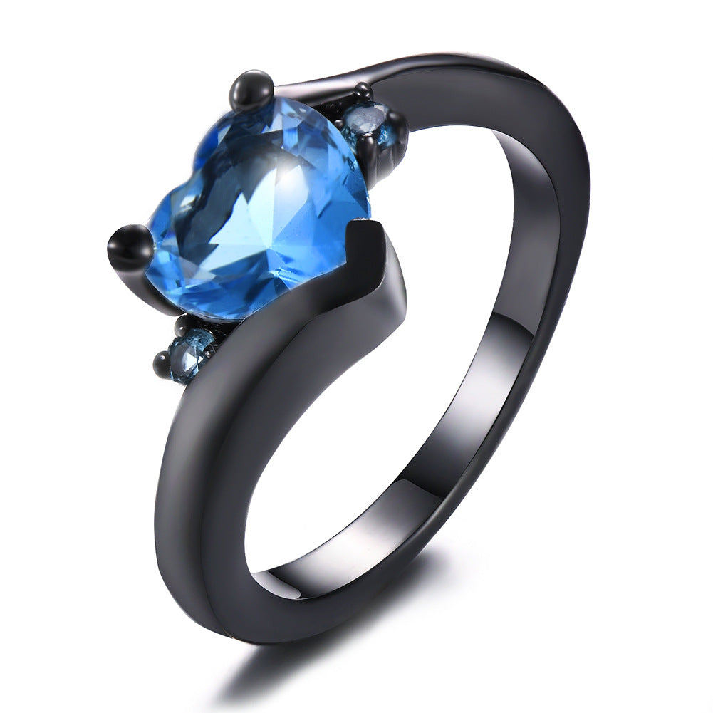 Damen Ring mit herzförmigem blauen Zirkonstein und eleganter schwarzer Fassung Shop Nory