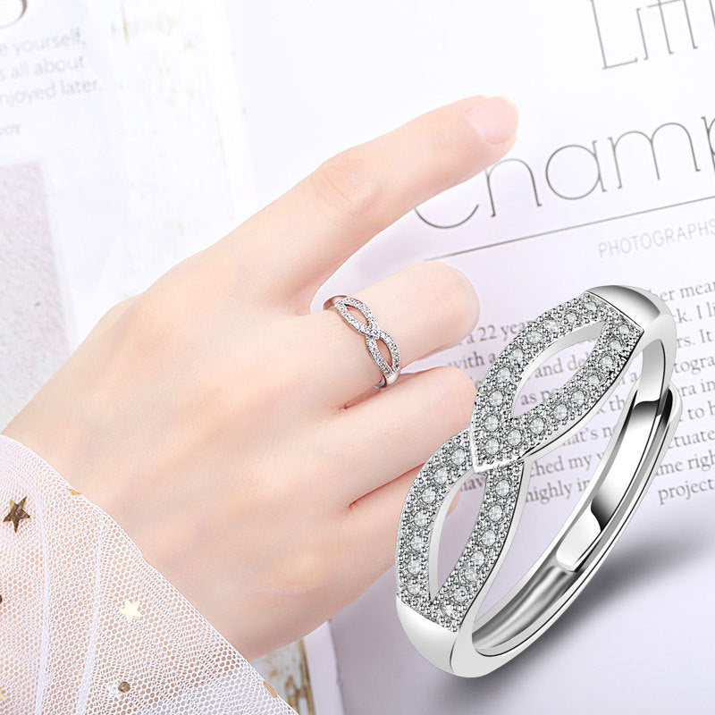 Damen filigraner Ring mit eleganter Schleifenstruktur und funkelndem Zirkonia Shop Nory