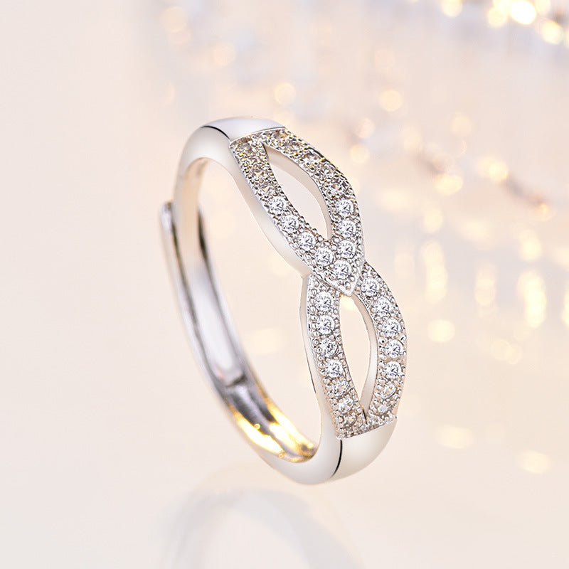 Damen filigraner Ring mit eleganter Schleifenstruktur und funkelndem Zirkonia Shop Nory