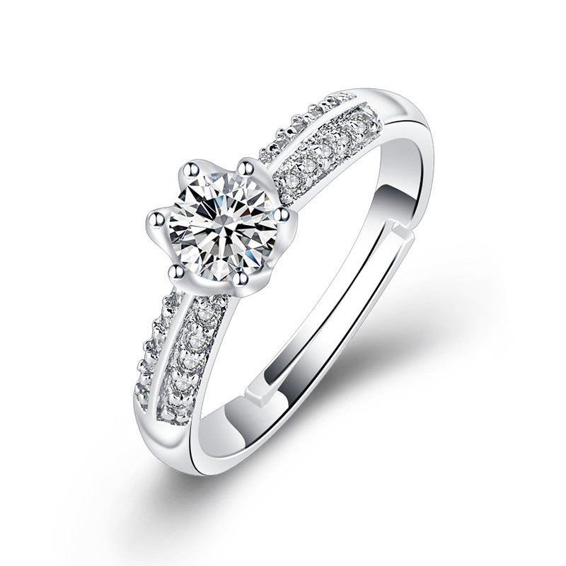 Damen Verlobungsring mit funkelndem Zirkonia-Besatz und eleganter Blumenkopfform Shop Nory