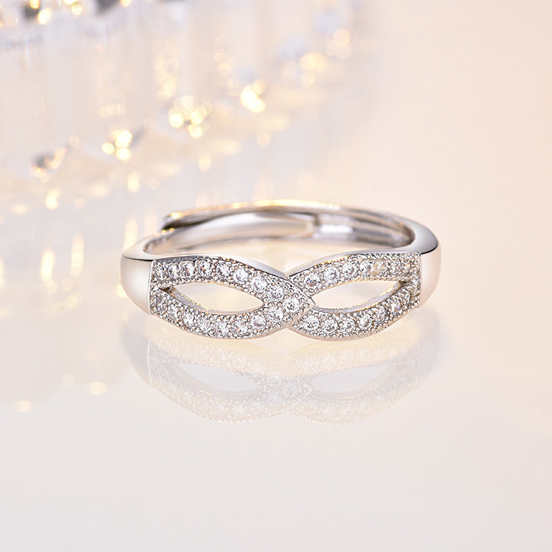 Damen filigraner Ring mit eleganter Schleifenstruktur und funkelndem Zirkonia Shop Nory