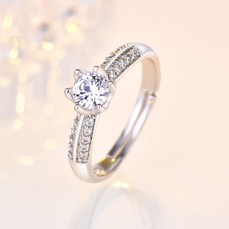 Damen Verlobungsring mit funkelndem Zirkonia-Besatz und eleganter Blumenkopfform Shop Nory
