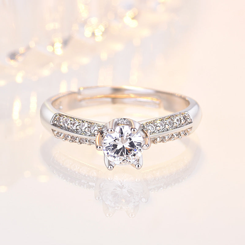 Damen Verlobungsring mit funkelndem Zirkonia-Besatz und eleganter Blumenkopfform Shop Nory
