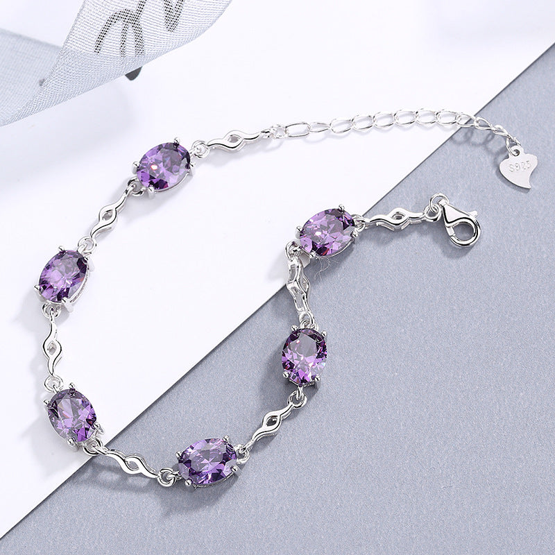 Damen Armband mit lila Schmucksteinen und elegantem Wellenmuster Shop Nory