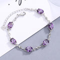 Damen Elegantes Armband mit funkelnden ovalen Edelsteinen und geschwungenem Design Shop Nory