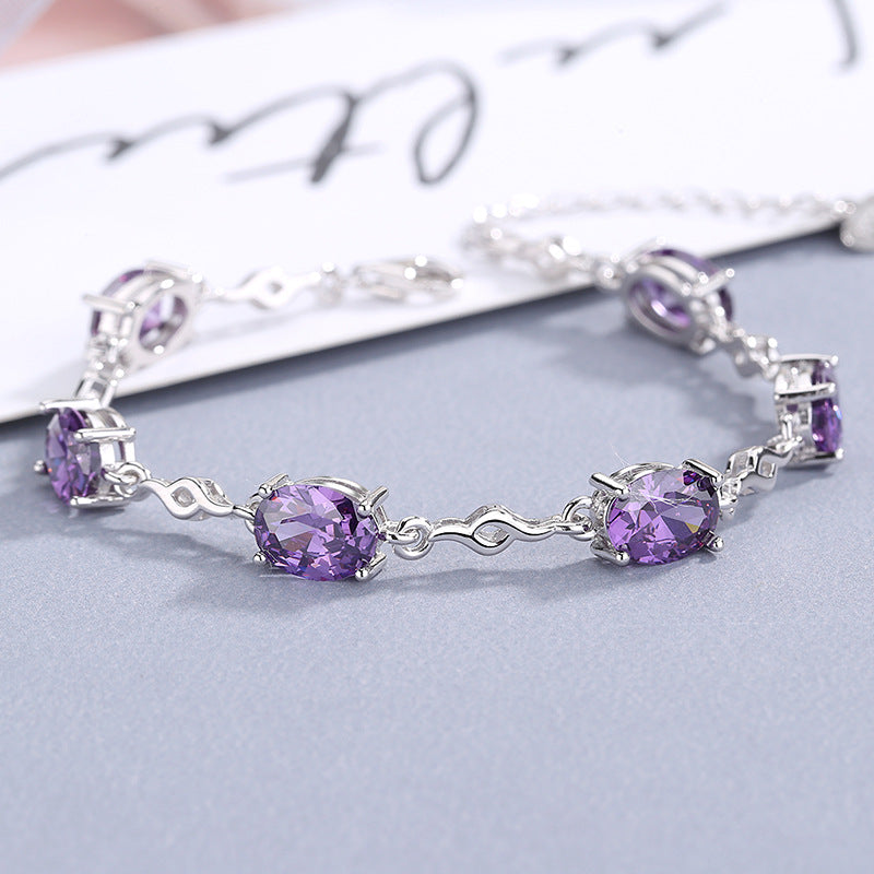 Damen Elegantes Armband mit funkelnden ovalen Edelsteinen und geschwungenem Design Shop Nory