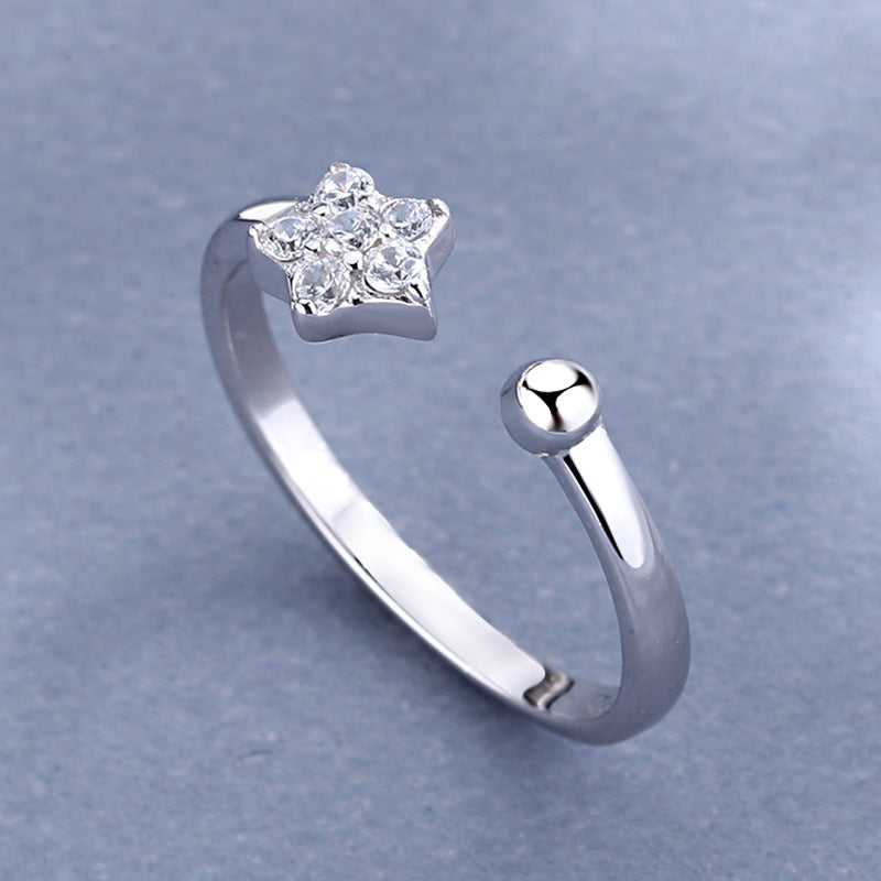 Damen Ring mit funkelndem Sternenanhänger und elegantem, offenen Design Shop Nory