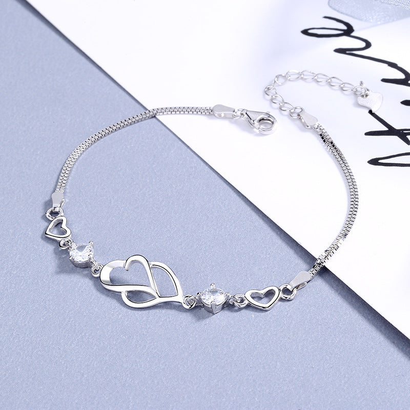 Damen Armband mit doppeltem Herzdesign und funkelnden Amethyststeinen Shop Nory