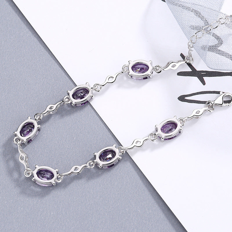 Damen Elegantes Armband mit funkelnden ovalen Edelsteinen und geschwungenem Design Shop Nory