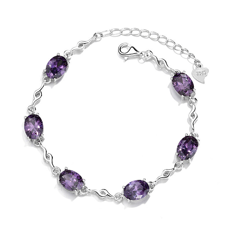 Damen Armband mit lila Schmucksteinen und elegantem Wellenmuster Shop Nory