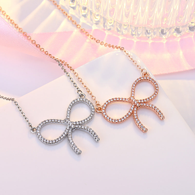Damen Halskette mit funkelndem Schleifenanhänger und hochwertigem Zirkonia-Besatz Shop Nory