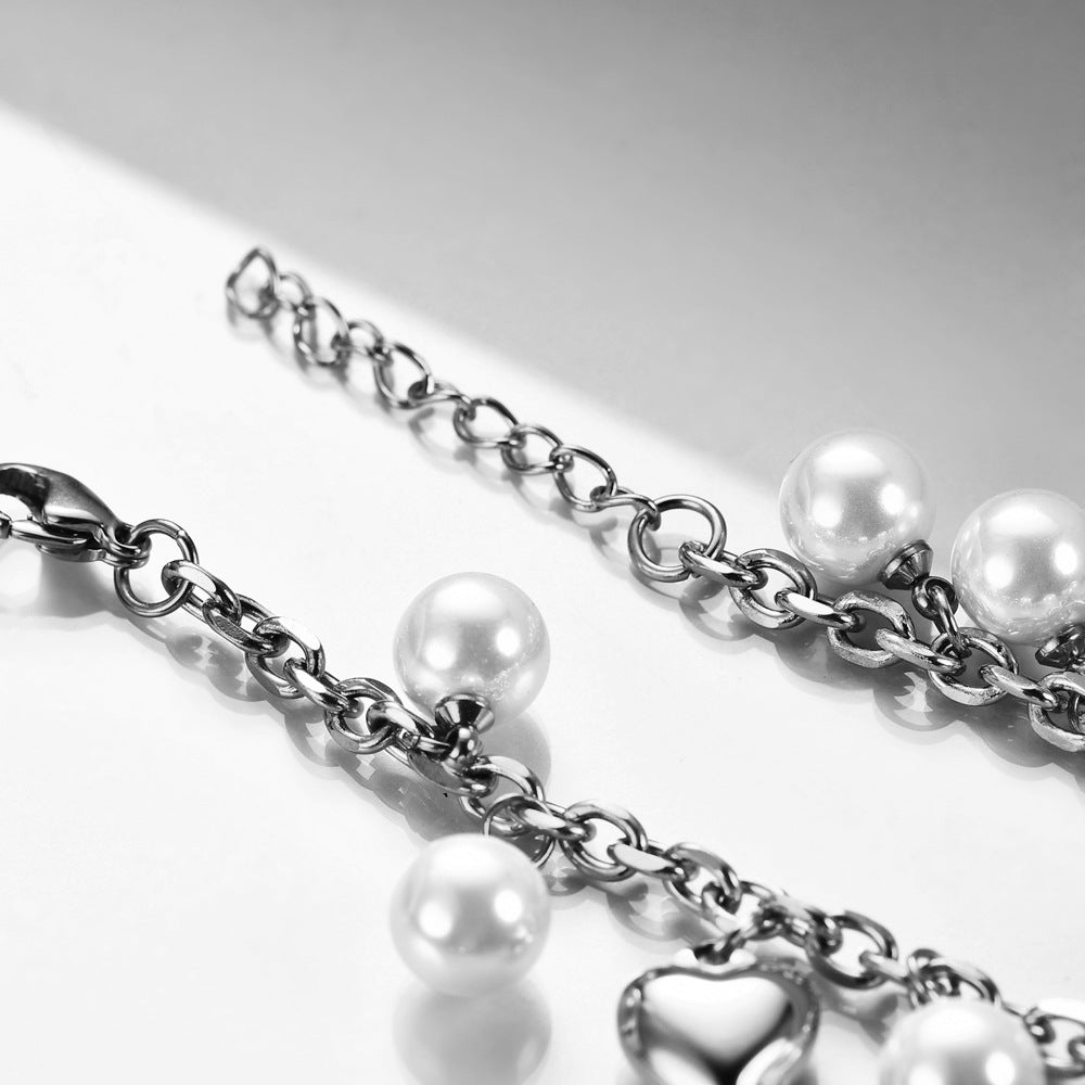 Damen Armband mit perlenbesetzten Herzen und Kreuzanhängern Shop Nory