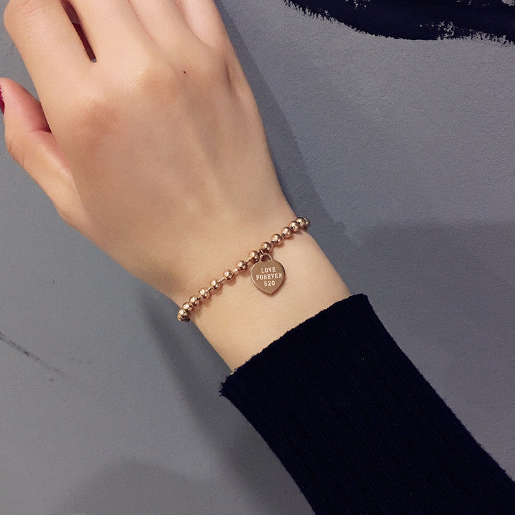 Damen Armband mit herzförmigem Anhänger und Kugeldesign Shop Nory