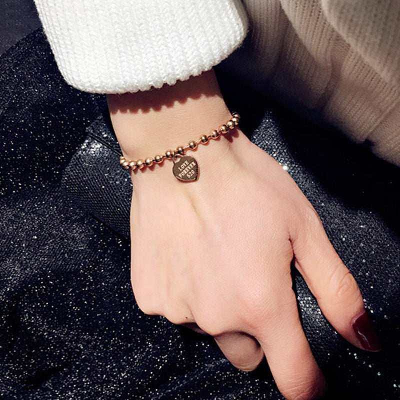 Damen Armband mit herzförmigem Anhänger und Kugeldesign Shop Nory