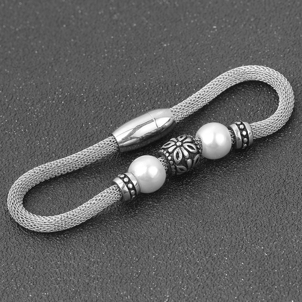 Damen Edelstahlarmband mit eleganten Perlen und kunstvollen Akzenten Shop Nory
