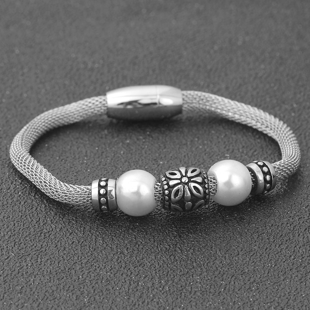 Damen Edelstahlarmband mit eleganten Perlen und kunstvollen Akzenten Shop Nory