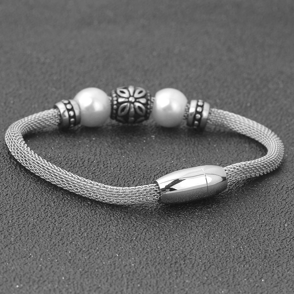 Damen Edelstahlarmband mit eleganten Perlen und kunstvollen Akzenten Shop Nory