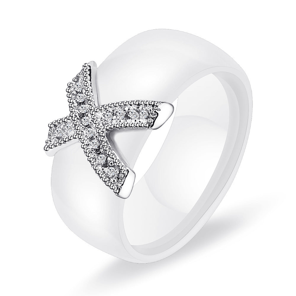 Damen Ring mit funkelndem Kristallbesatz und modernem Kreuzdesign Shop Nory