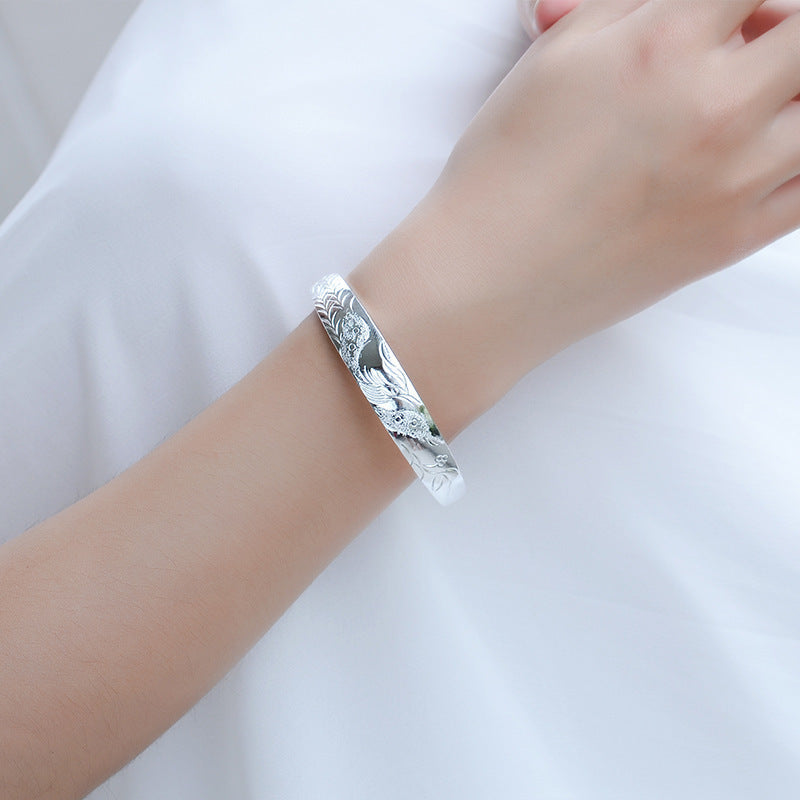 Damen Silberarmband mit kunstvollem Vogelmotiv und feiner Textur Shop Nory