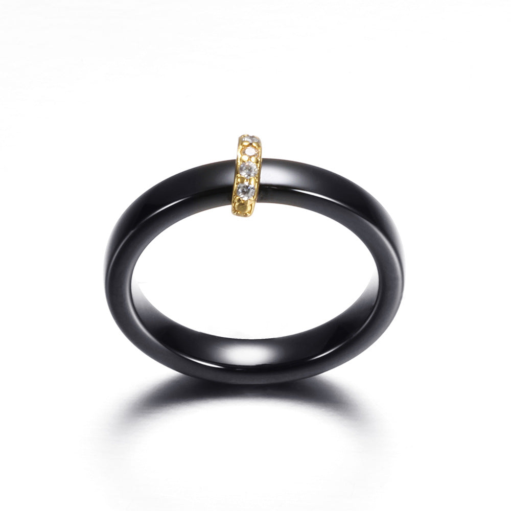 Damen Ring mit elegantem schwarzem Keramikkern und goldenem Zirkonia-Besatz Shop Nory