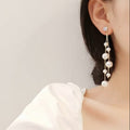 Damen goldbeschichtete simulierte Perlen Doppelperlen lange hängende Stud Ohrringe | Shop Nory