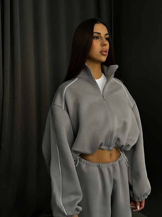 Damen cropped Zip-Kapuzenjacke mit Tunnelzug-Bund, oversized Ärmeln und kontrastierender Paspel Shop Nory