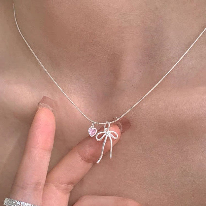 Damen Halskette mit elegantem Schleifenanhänger und herzförmigem Kristall Shop Nory