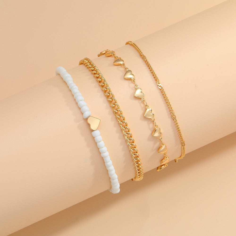 Damen Fußkettchen-Set mit eleganten goldenen und weißen Akzenten Shop Nory