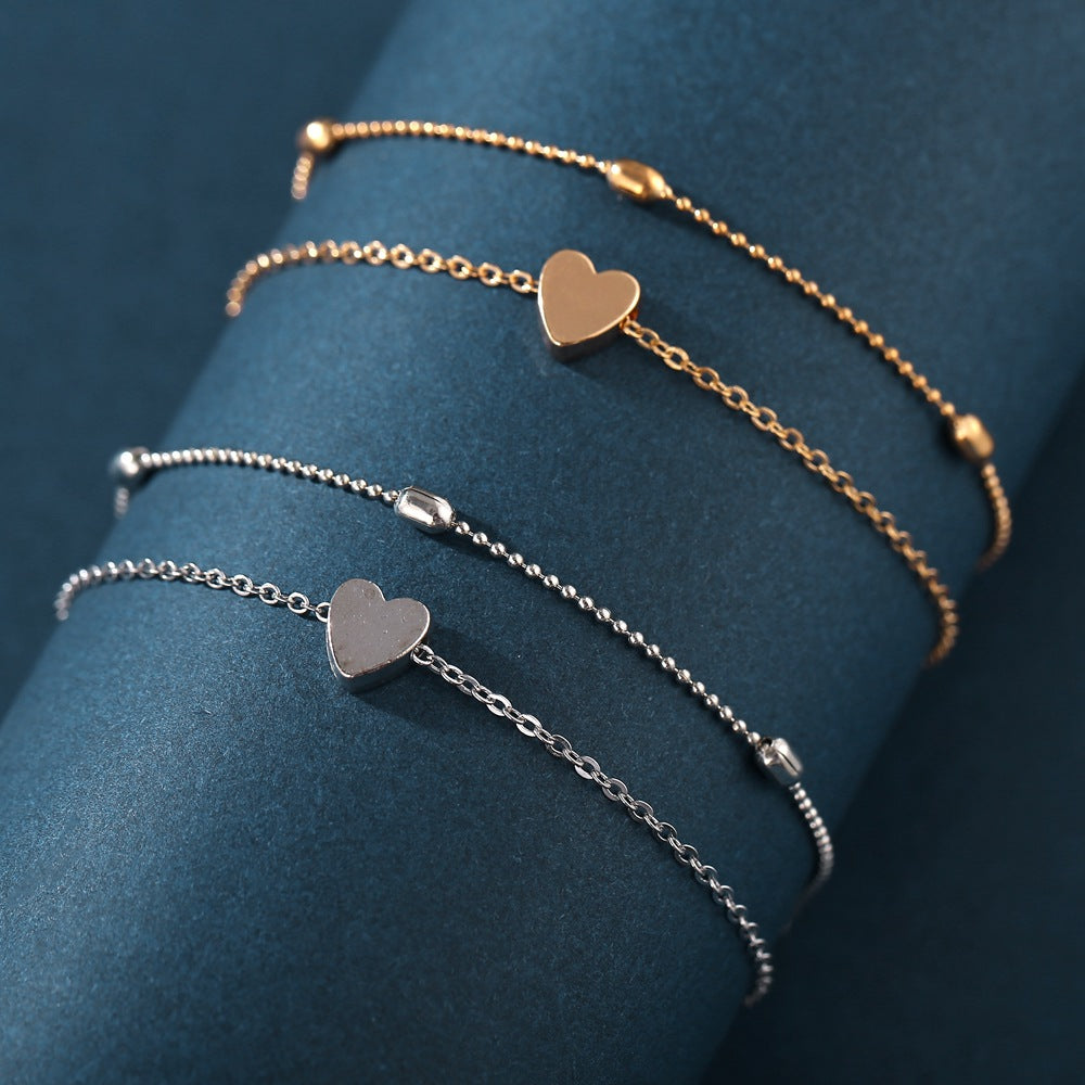 Damen Fußkettchen mit herzförmigen Anhängern und filigranen Details Shop Nory