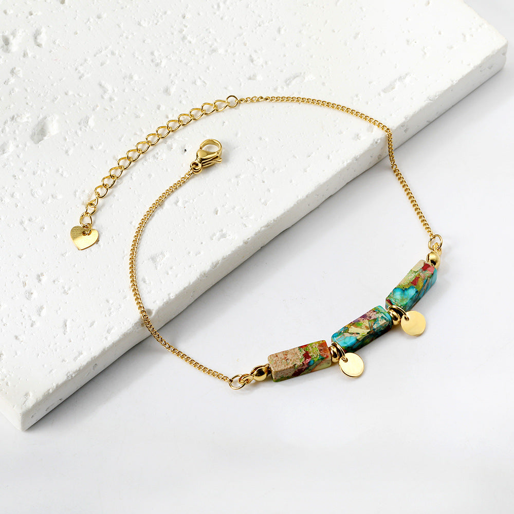Damen Armband mit funkelnden Karibikstein-Elementen aus hochwertigem Edelstahl und goldplattierten Akzenten Shop Nory