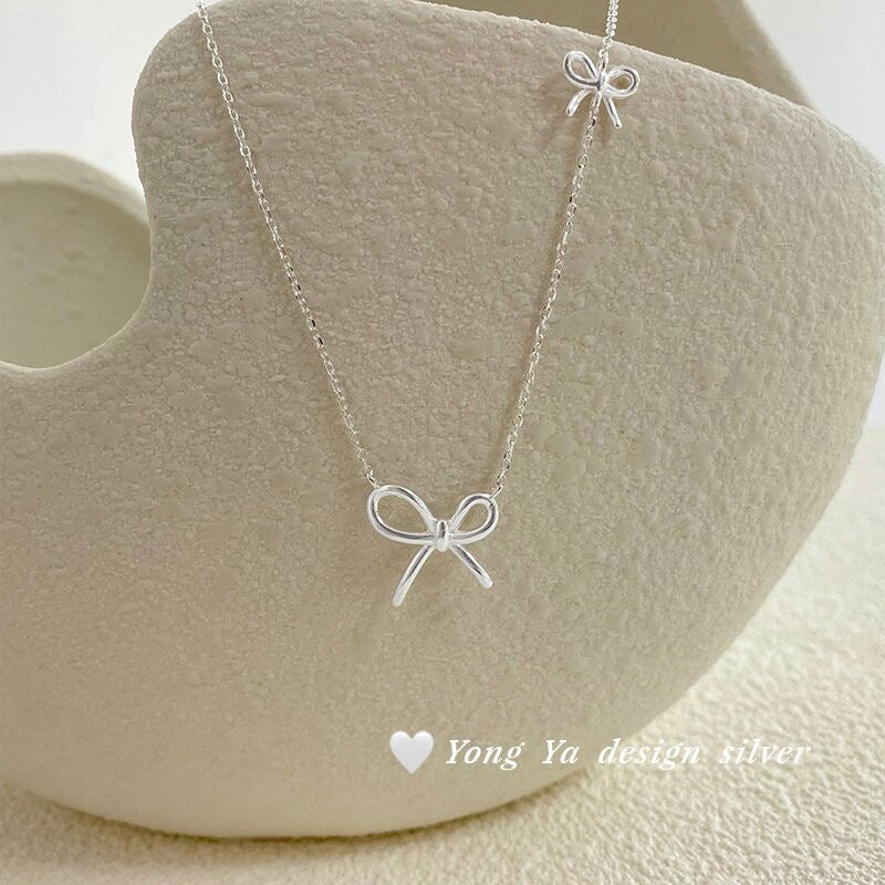 Damen Silberne Halskette mit stilvollem Schleifen-Design Shop Nory