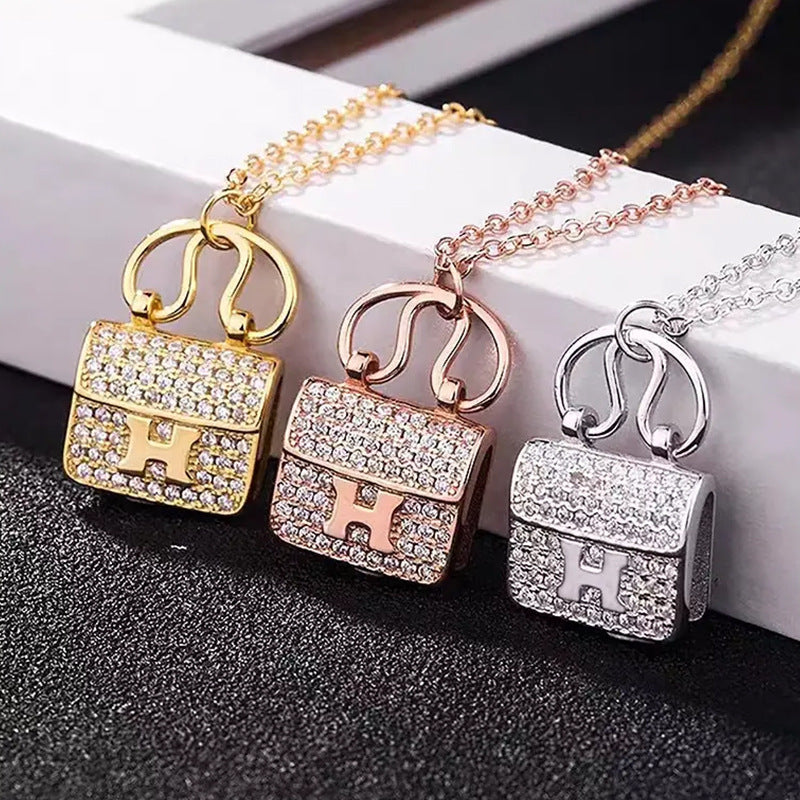 Damen Halskette mit kunstvollem Handtaschen-Anhänger aus funkelndem Zirkonia Shop Nory