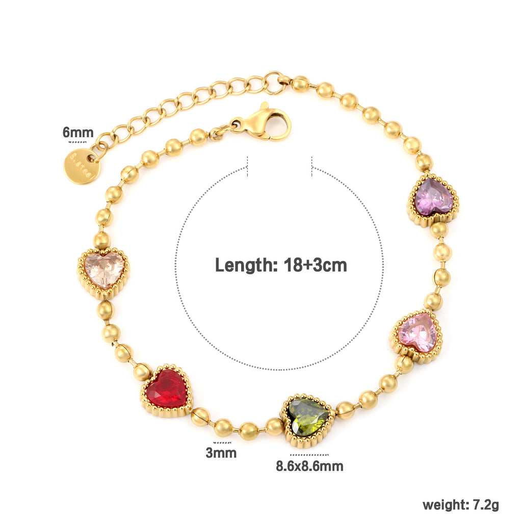 Damen Armband mit schimmernden goldenen Perlen und funkelndem Herzanhänger Shop Nory