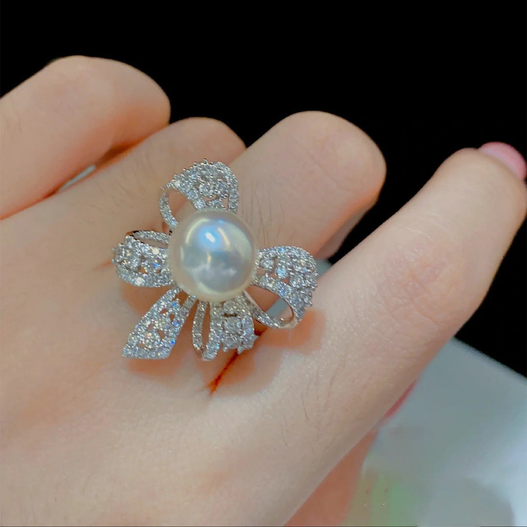 Damenring mit elegantem Schleifenmotiv und strahlender Perle Shop Nory