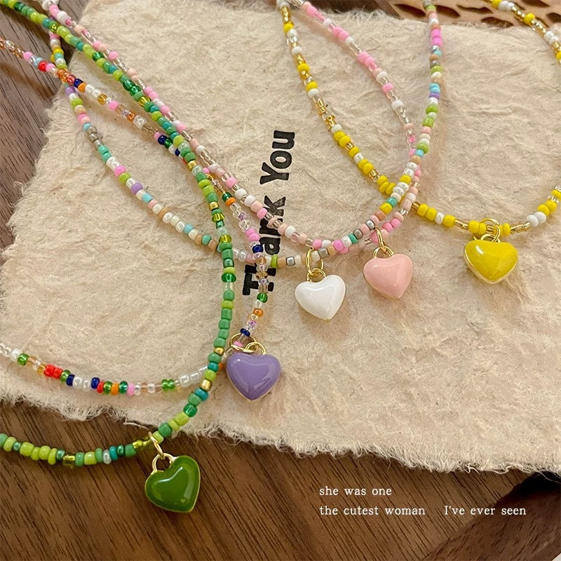 Damen Halskette mit bunten Perlen und herzförmigem Anhänger Shop Nory