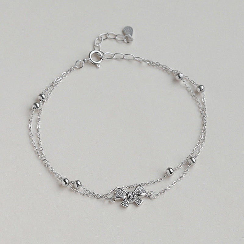 Damen Armband mit zartem Schleifen-Design und funkelnden Kristallen Shop Nory