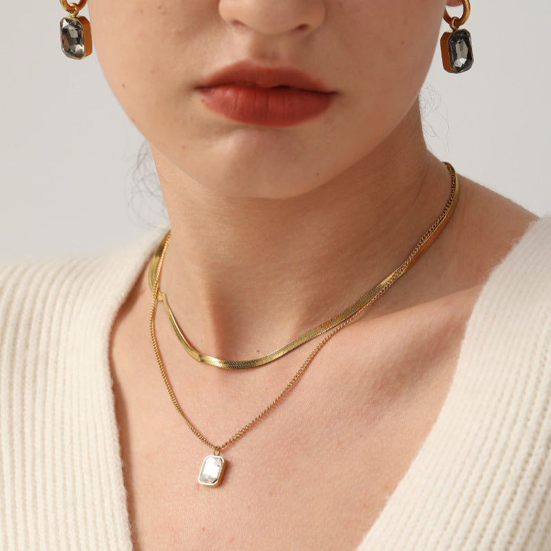 Damen Edelstahl Ohrhänger mit funkelnden Zirkonia und goldplattiertem Design Shop Nory