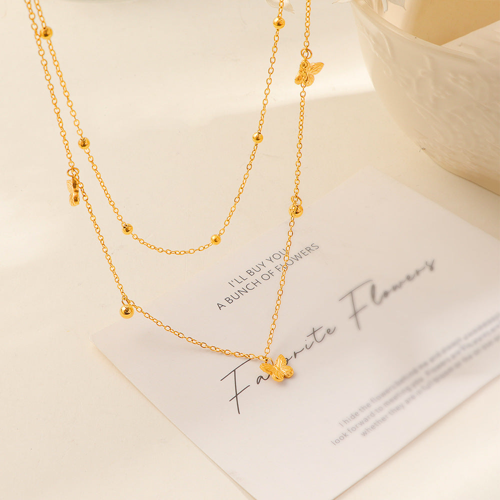 Damen mehrlagige Halskette mit filigranen Schmetterlings- und Kugeldetails Shop Nory