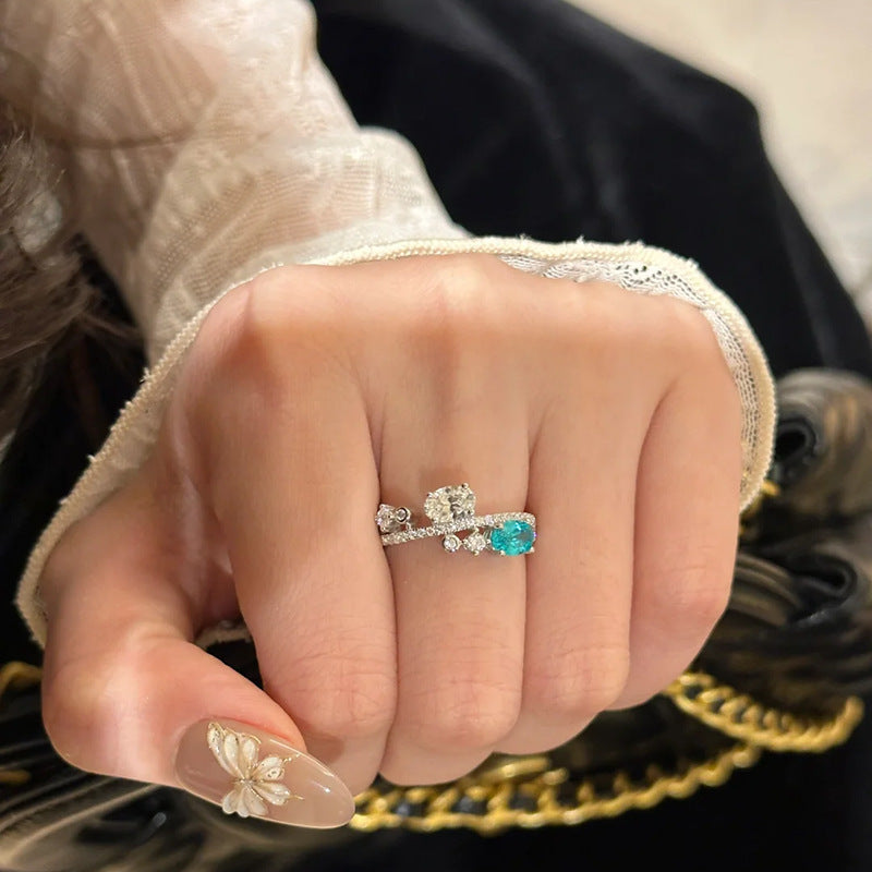 Damenring mit funkelnden Zirkonia und elegantem Türkisakzent Shop Nory