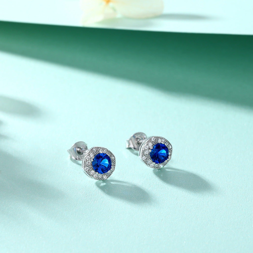 Damen Ohrstecker mit strahlendem blauen Hauptstein und kunstvollen Zirkonia-Details Shop Nory