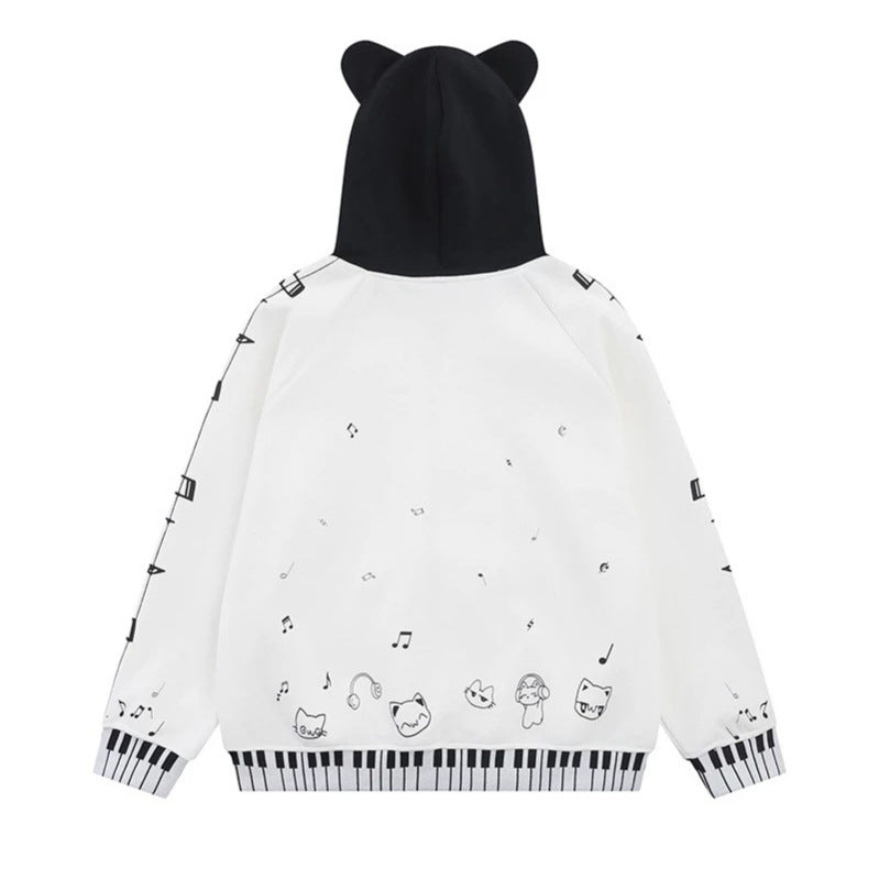 Damen Kapuzensweatjacke mit durchgehendem Reißverschluss, Musikprint, Klaviertasten‑Bündchen und Ohrenkapuze Shop Nory