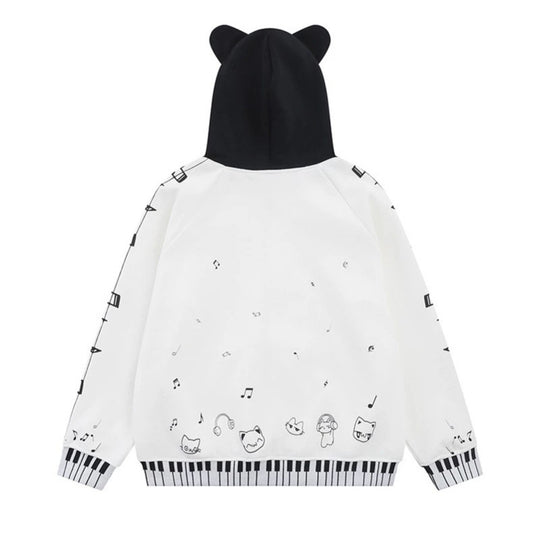 Damen Kapuzensweatjacke mit durchgehendem Reißverschluss, Musikprint, Klaviertasten‑Bündchen und Ohrenkapuze Shop Nory