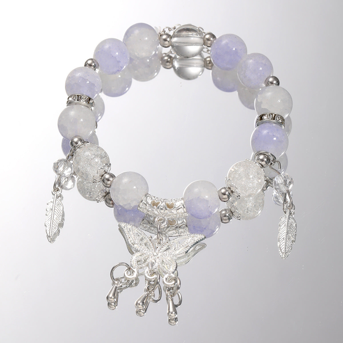 Damenarmband mit funkelnden Glaskugeln und filigranen Schmetterlingen Shop Nory