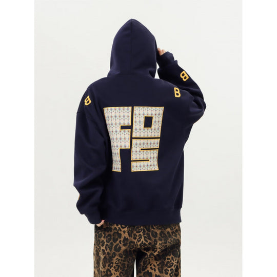 Unisex Oversized Kapuzenpullover mit großflächigem Intarsien‑Blockprint und geripptem Saum Shop Nory