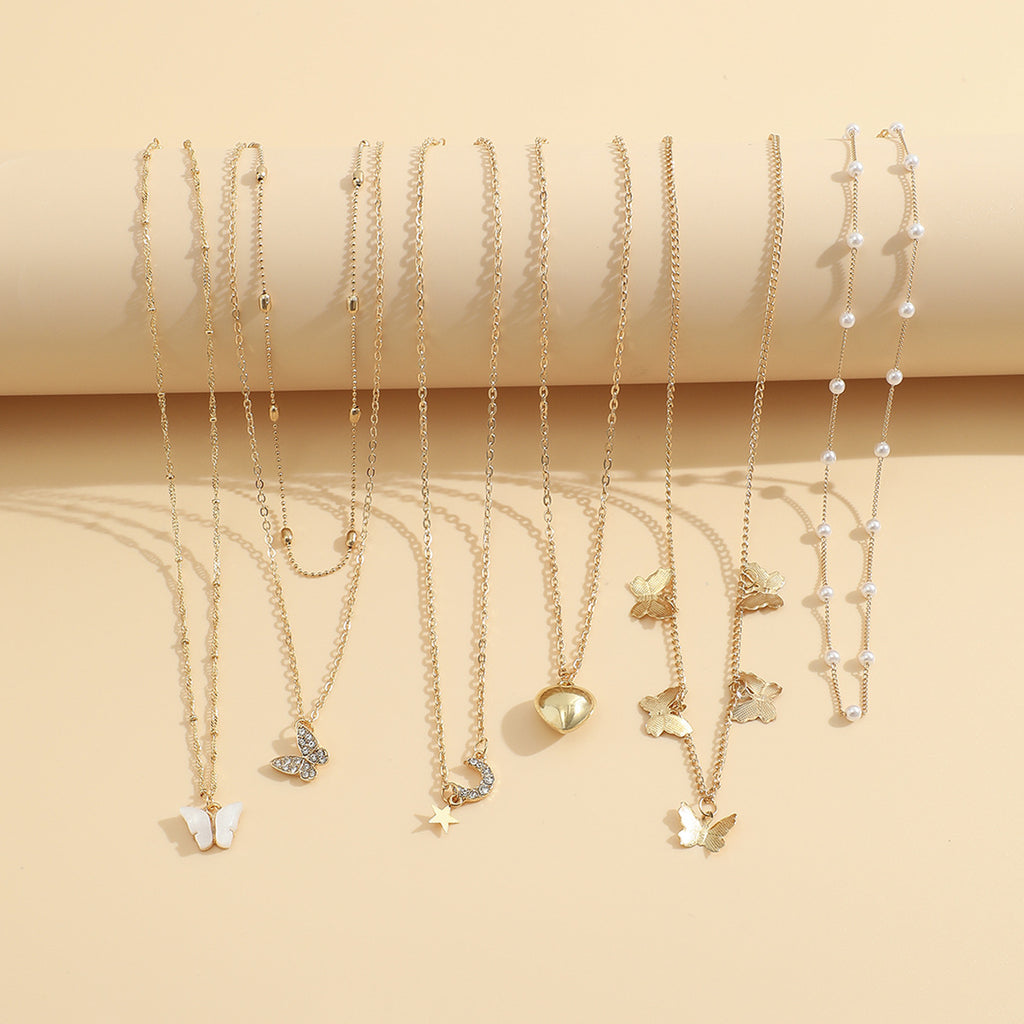 Damen Halskette Set aus feinen goldenen Ketten mit verspielten Anhängern Shop Nory