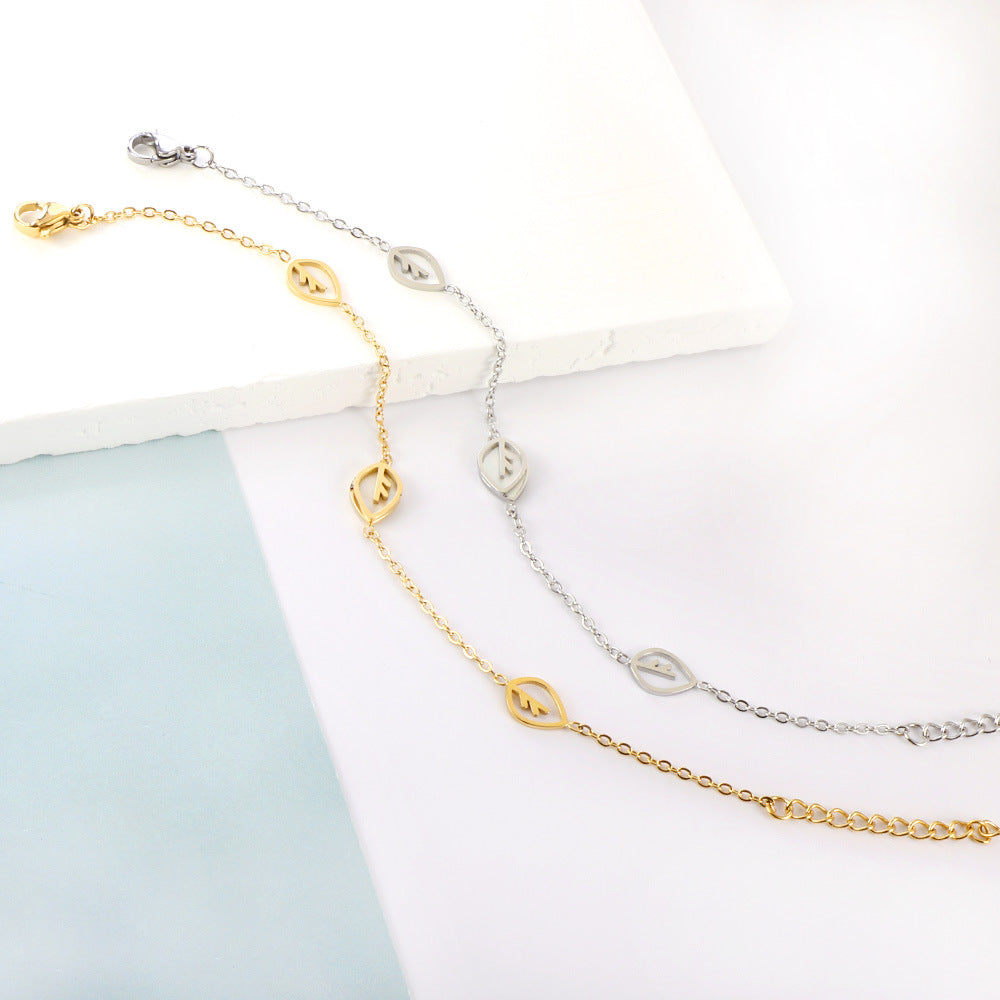 Damen Armband mit feinen Blattmotiven aus Edelstahl und goldplattierter Oberfläche Shop Nory