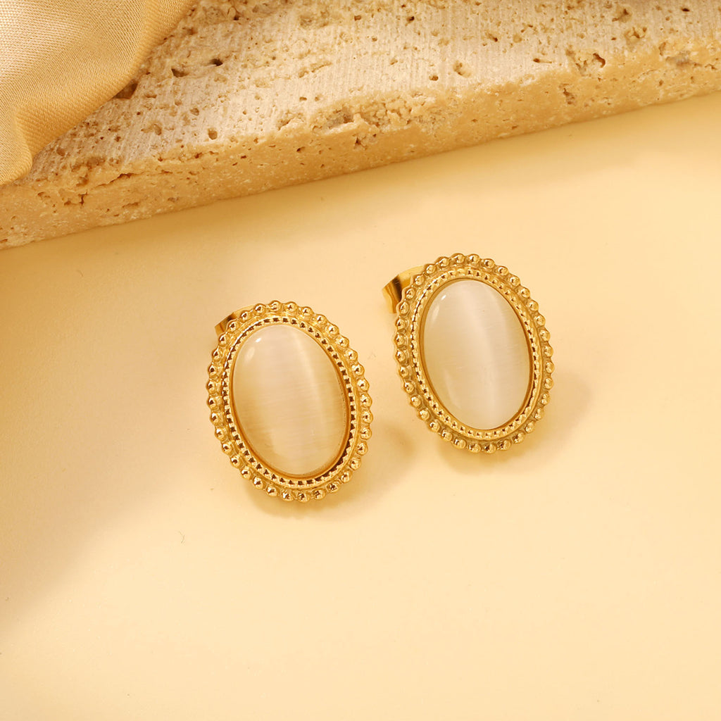 Damen Ohrstecker mit ovalem schwarzen Stein und goldfarbenem Rand Shop Nory