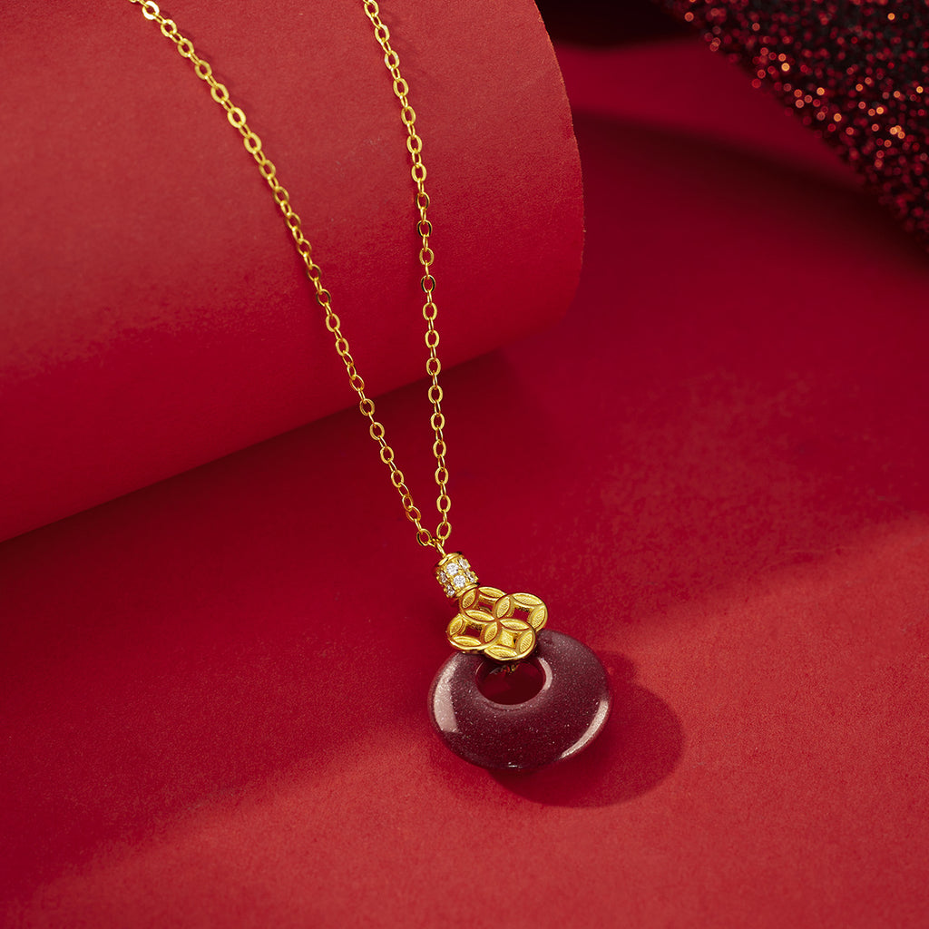 Damen Anhänger-Halskette mit funkelndem goldfarbenen Detail und rotem Edelstein Shop Nory