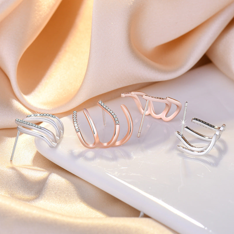Damen Ohrringe mit kunstvollem Wellen-Design und funkelnden Zirkonia Shop Nory