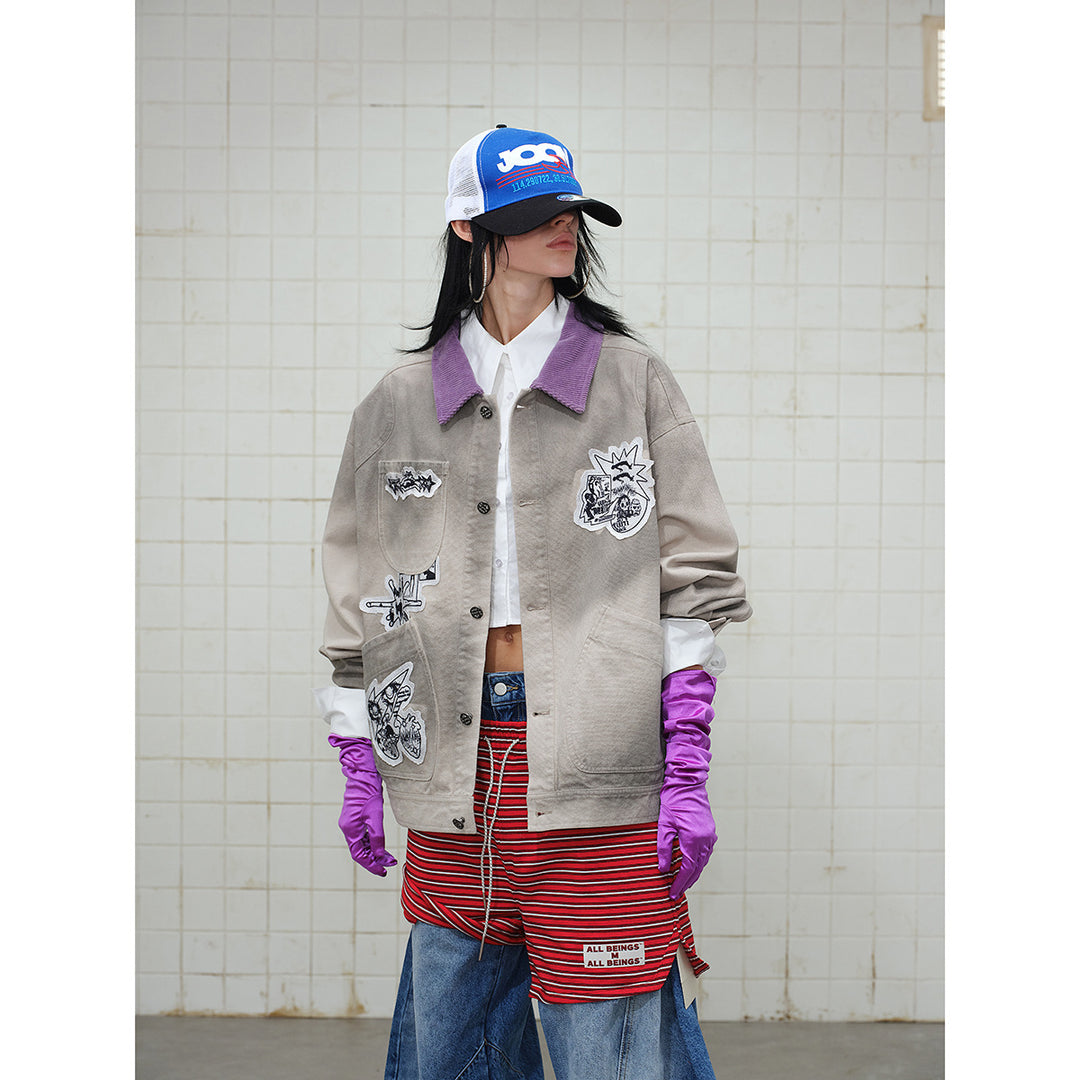 Unisex Kastig geschnittene Chorejacke aus Baumwollcanvas mit artistischen Patch Applikationen und Cordkragen Shop Nory